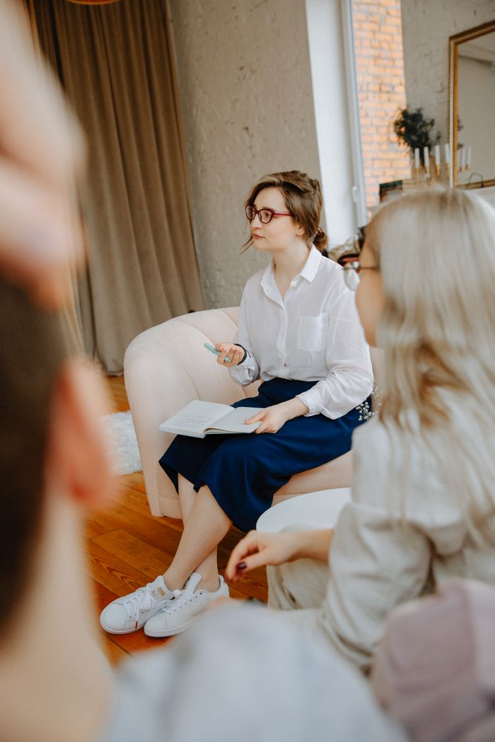 Mastering the First Impression: Your intriguing post title goes here A therapist leading a counseling session with a couple in a cozy room setting.